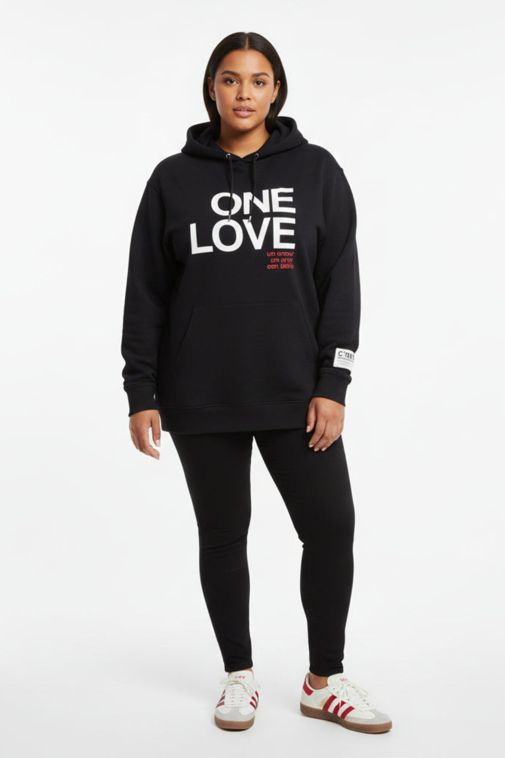 Women wearing a black hoodie with 'ONE LOVE' text on a white background