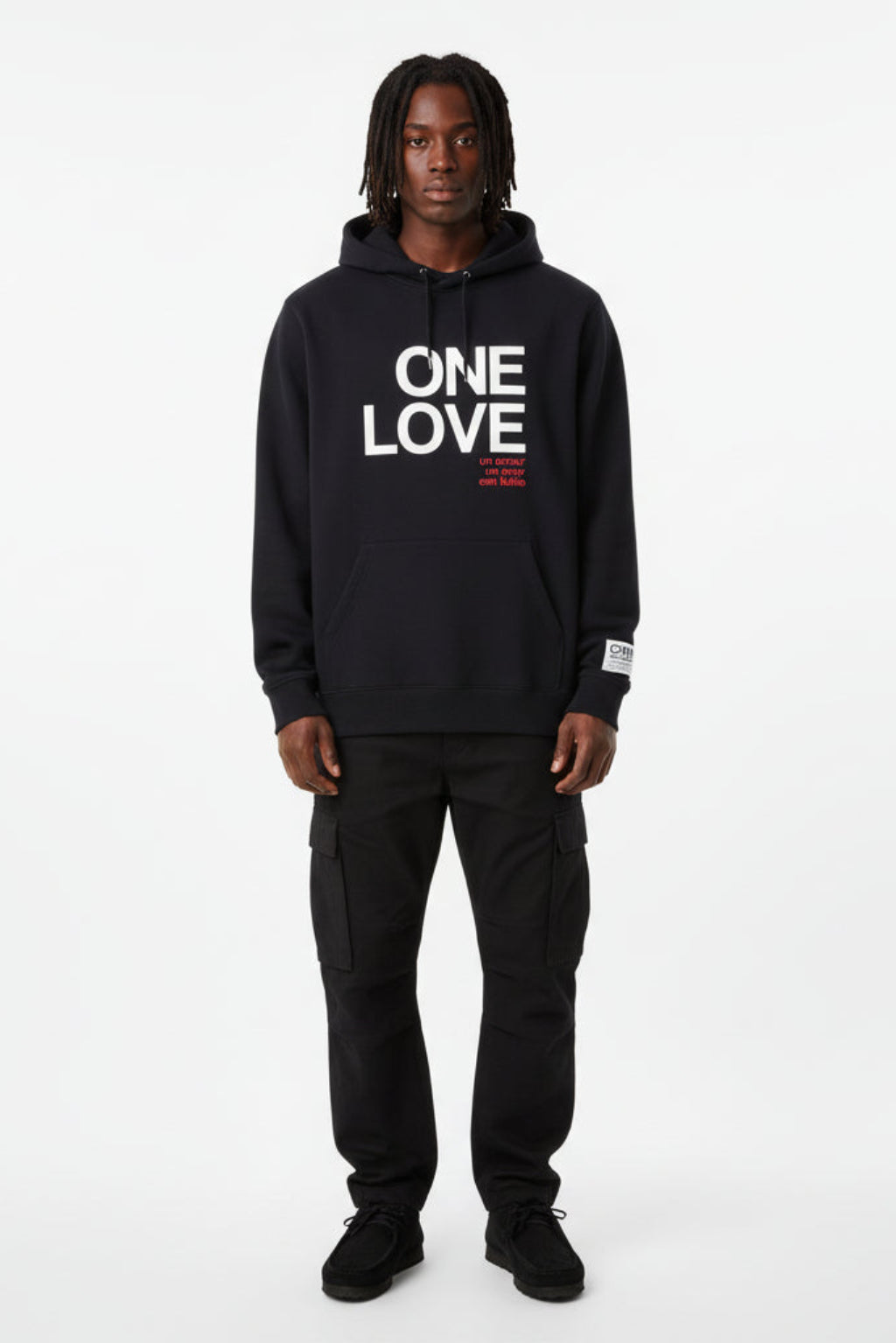 Man wearing a black hoodie with 'ONE LOVE' text on a white background