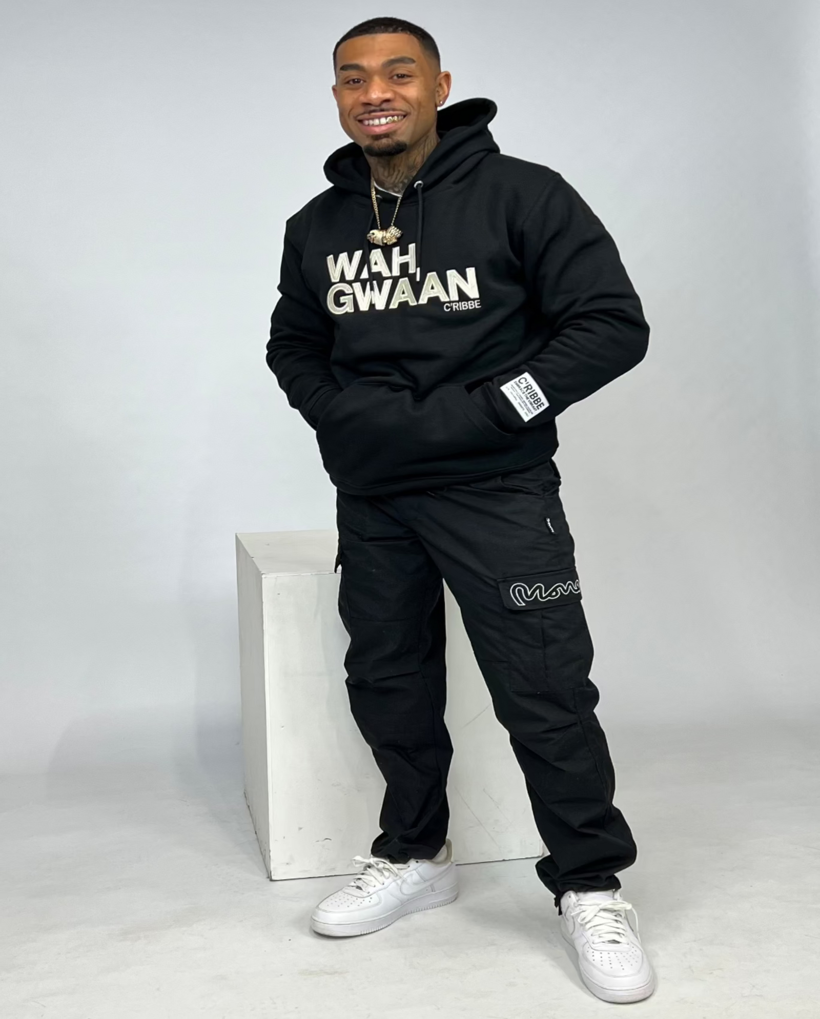 Black hoodie with 'WAH GWAAN' text on a white background
